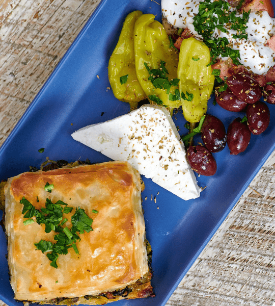 Acropolis Greek Taverna - Spanakopita: Light and Flaky Phyllo Pastry Dough Stuffed with Spinach and Cheese. Served with Tzatziki.