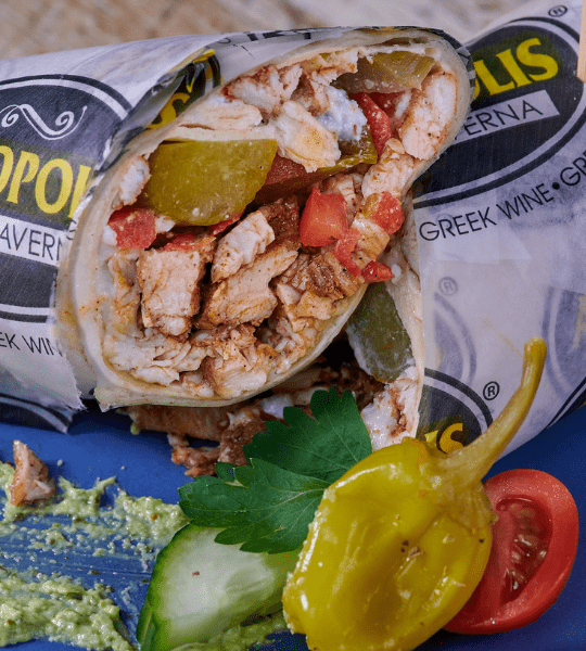 Acropolis Greek Taverna - Chicken Shawarma: Mediterranean Marinated Chicken Wrapped in Tortilla with Tomatoes, Pickles and Garlic.