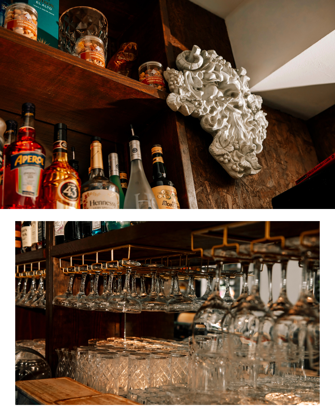 Acropolis Greek Taverna bar shelf with wine glasses and decorative Greek bust.