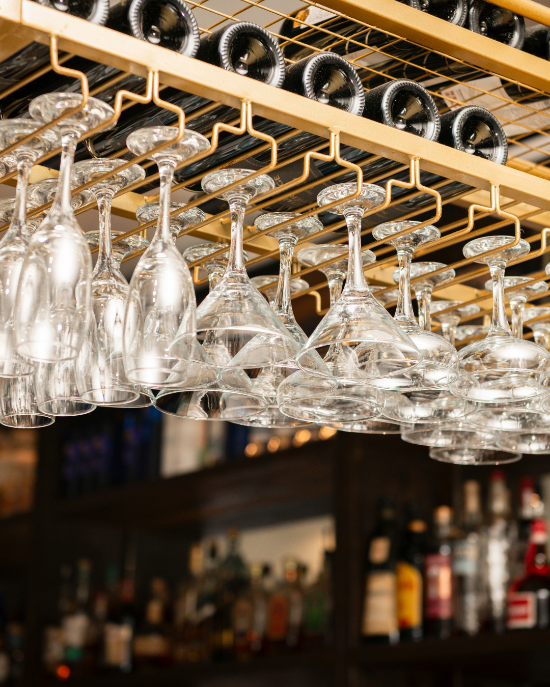 Hanging wine glasses on gold rack at Acropolis Greek Taverna South Tampa Kennedy Blvd