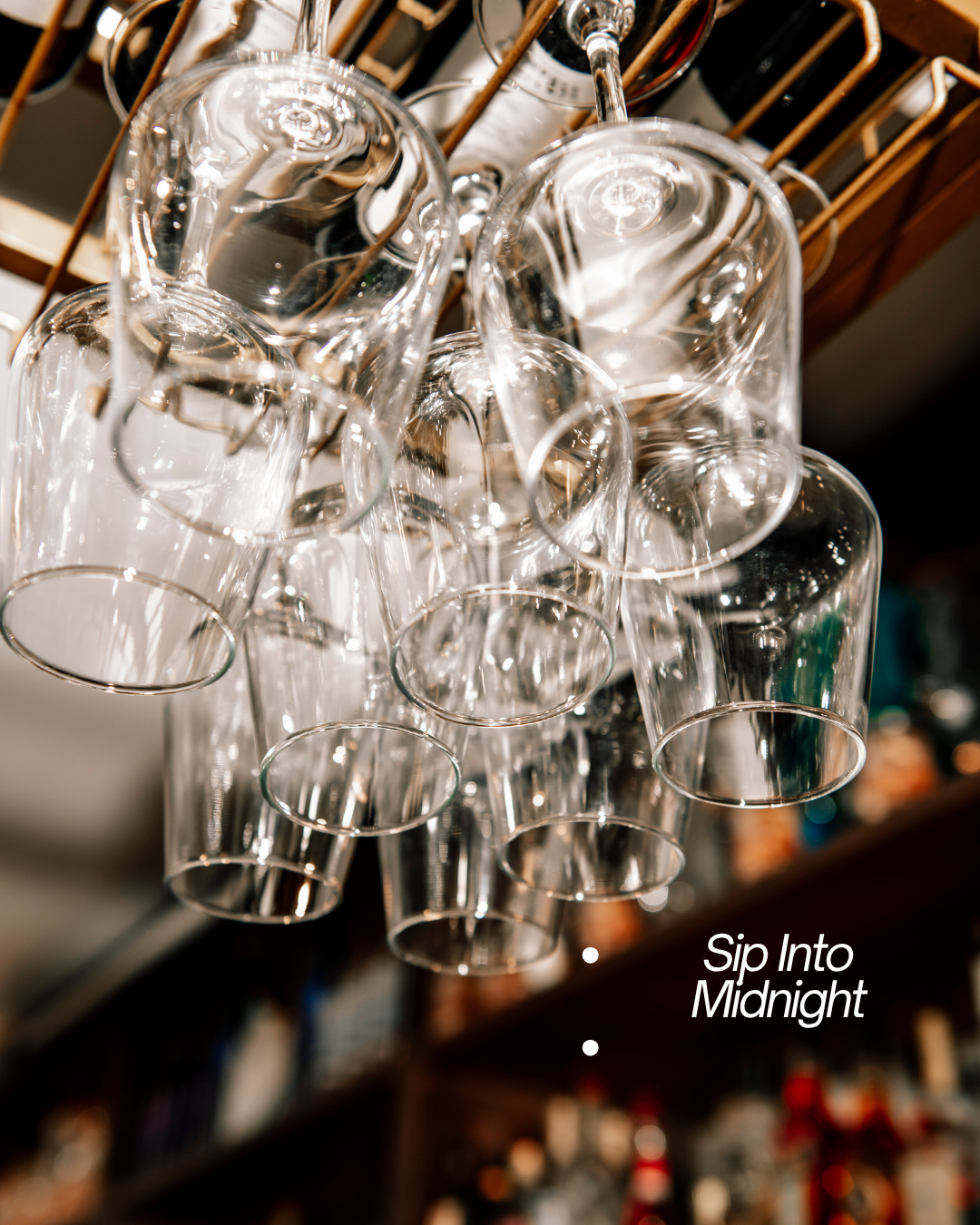 Hanging glasses and bottles at Acropolis Greek Taverna, inviting guests to sip into midnight.