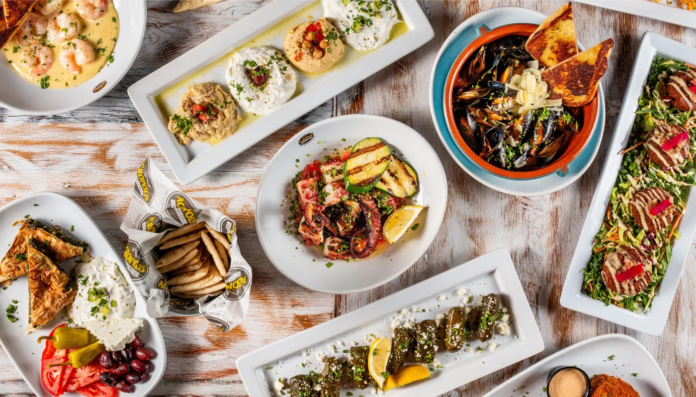 Assorted Greek and Mediterranean appetizers including shrimp, mussels, octopus, and pita bread at Acropolis Greek Taverna.