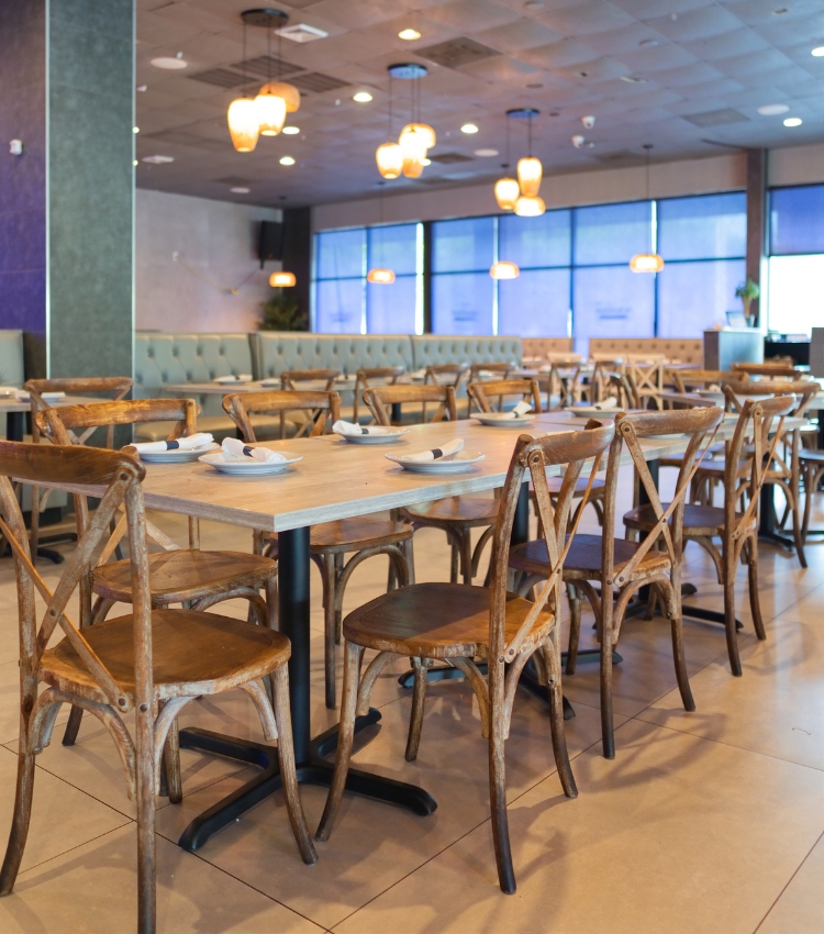 Acropolis Greek Taverna main dining room with tables and chairs ready for guests.