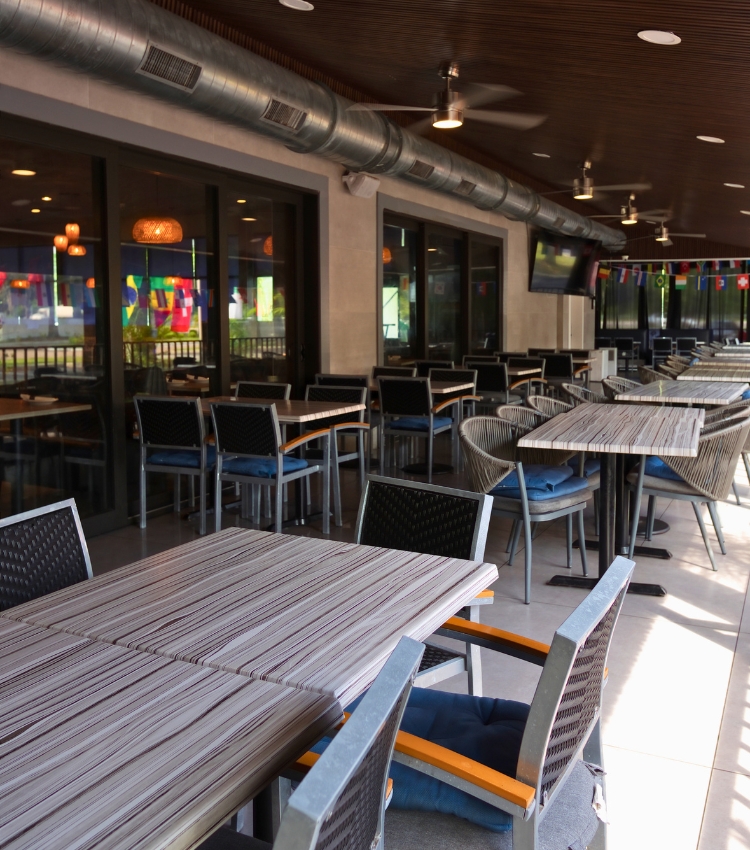 Acropolis Greek Taverna patio dining area with tables and chairs in North Tampa.