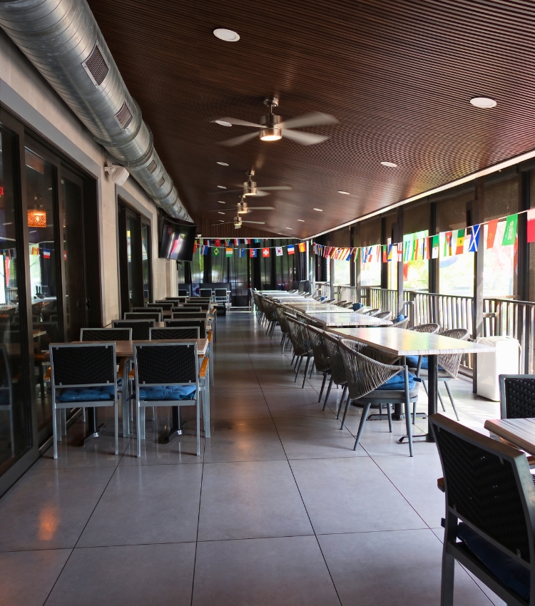 Acropolis Greek Taverna patio dining area in North Tampa with tables and chairs.